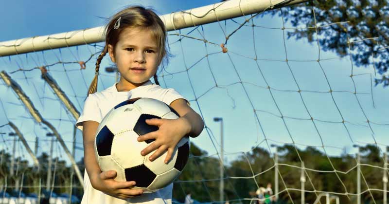 Young Girl Playing Soccer Goalie