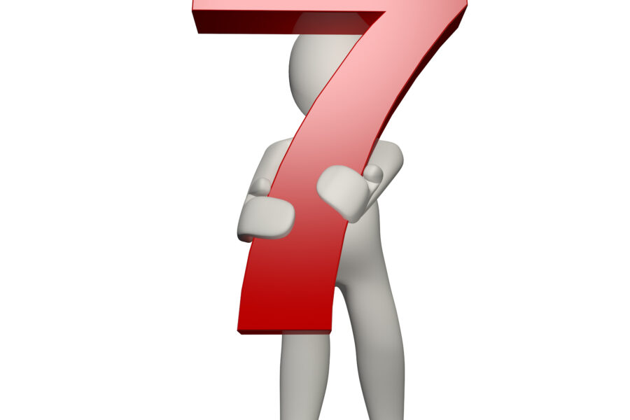 A 3D figure standing with arms crossed, holding a large red number seven in front of them. The background is plain white.