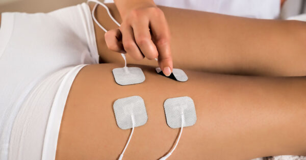 Female Athlete with Electrical Muscle Stimulator
